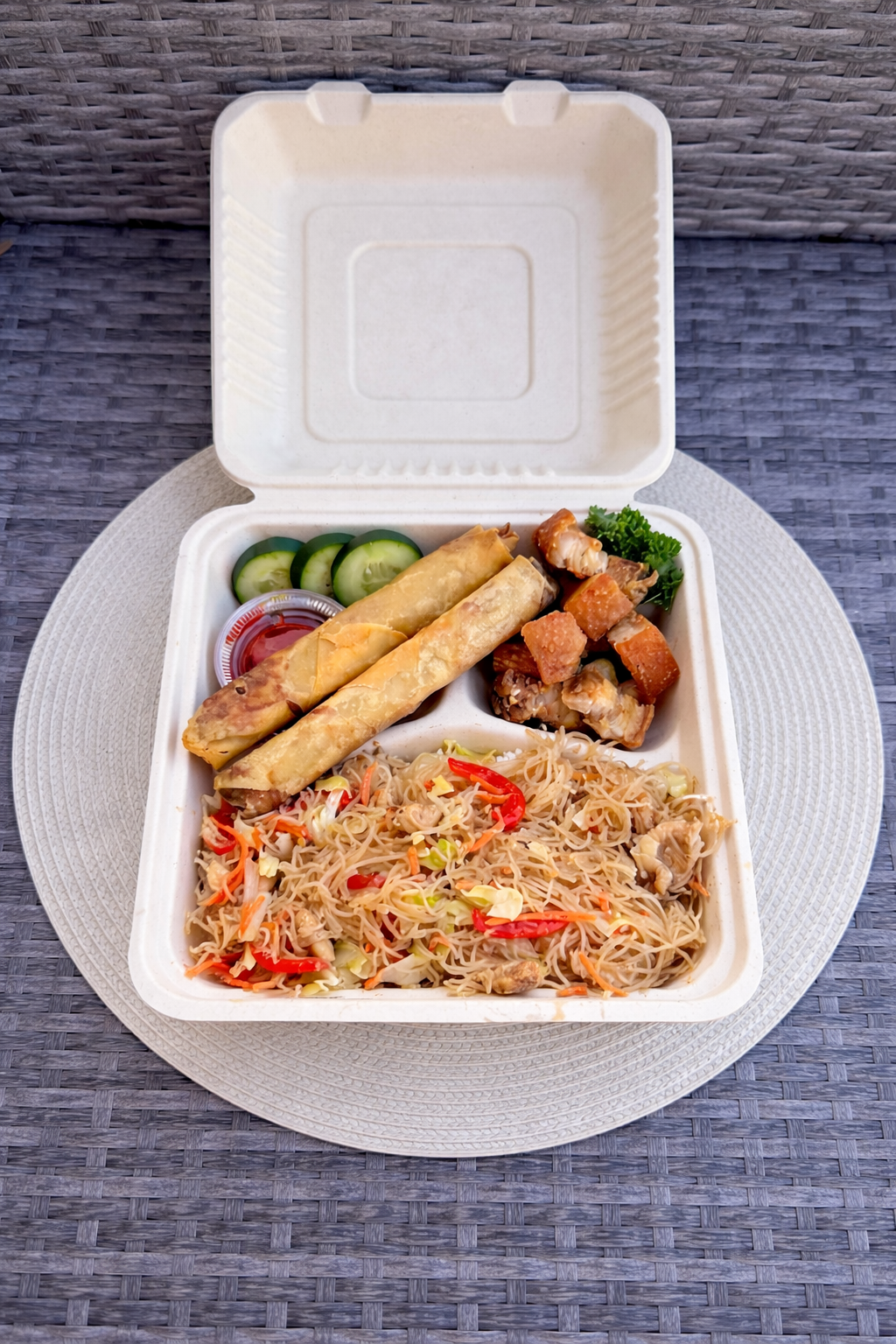 Filipino combo plate with lumpia, pancit and pork